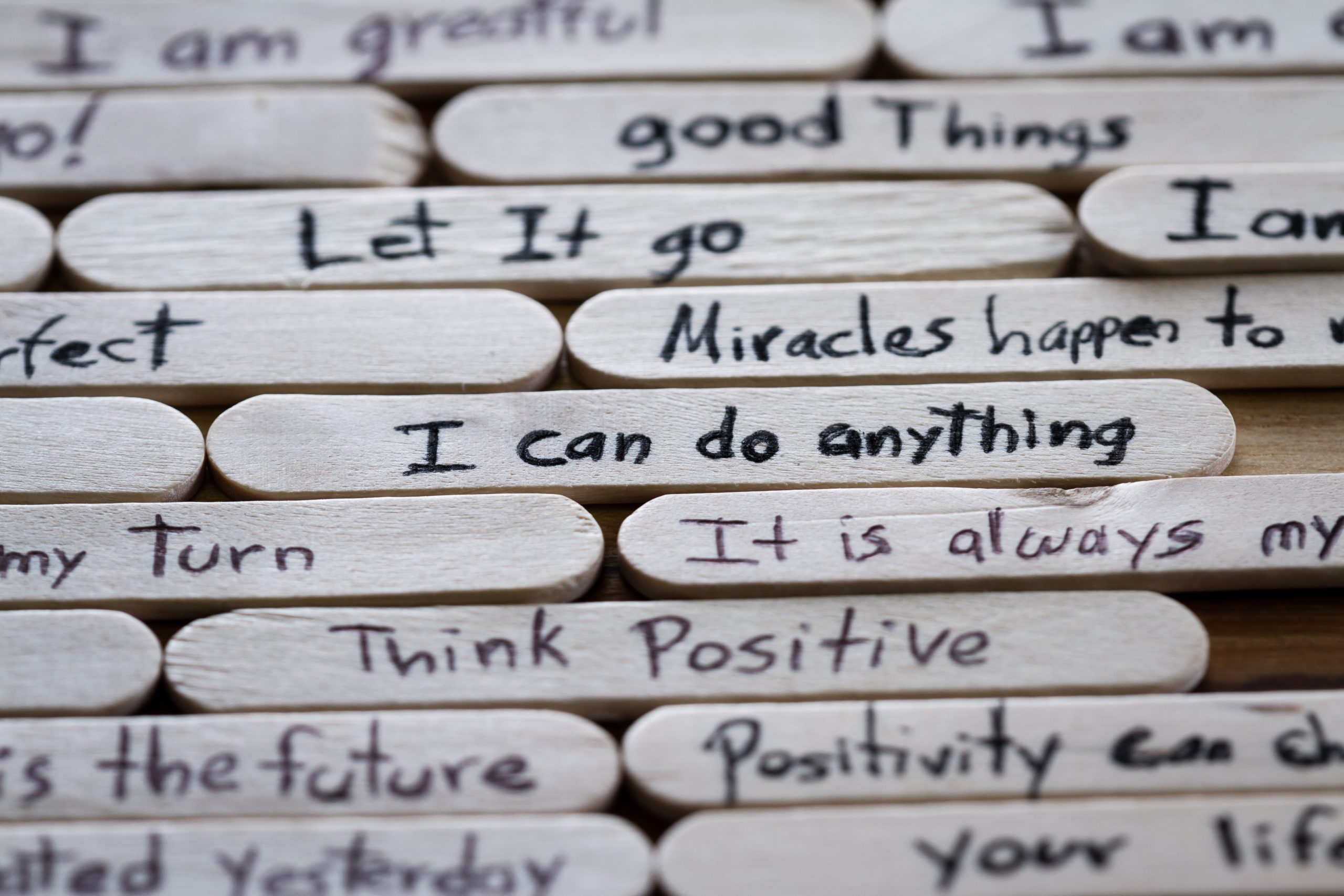 close up of a hand written message on a popsicle stick as a self esteem building concept