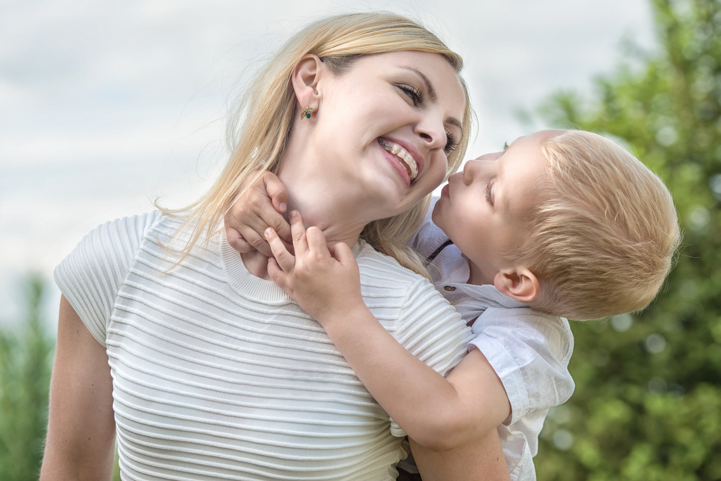 Little boy tenderly embraces his mother.